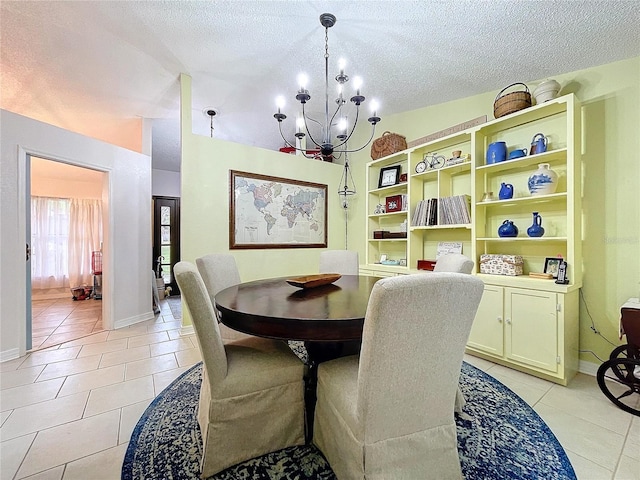 dining space featuring a notable chandelier, a textured ceiling, baseboards, and light tile patterned floors