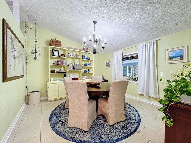 dining space with baseboards, lofted ceiling, a textured ceiling, a notable chandelier, and light tile patterned flooring