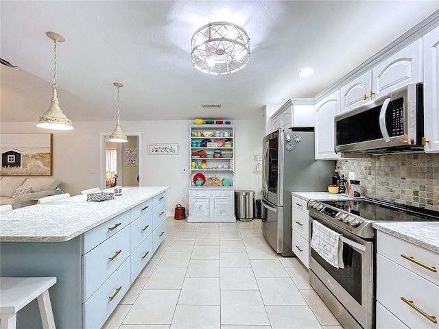 kitchen with decorative light fixtures, stainless steel appliances, tasteful backsplash, white cabinets, and a kitchen island