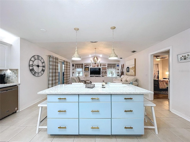 kitchen featuring dishwasher, a kitchen breakfast bar, and light tile patterned floors