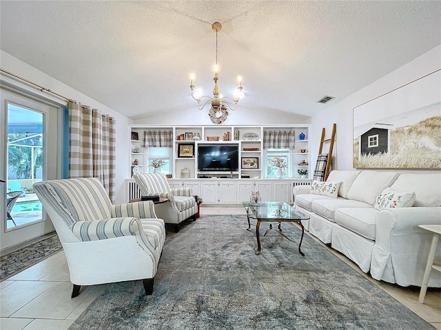 living area featuring a textured ceiling, built in shelves, visible vents, vaulted ceiling, and an inviting chandelier