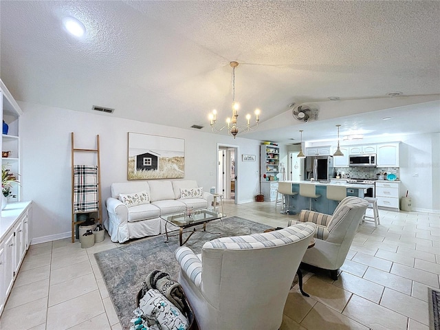 living room with light tile patterned floors, visible vents, an inviting chandelier, vaulted ceiling, and a textured ceiling