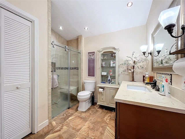 bathroom with toilet, vanity, a shower stall, a chandelier, and recessed lighting