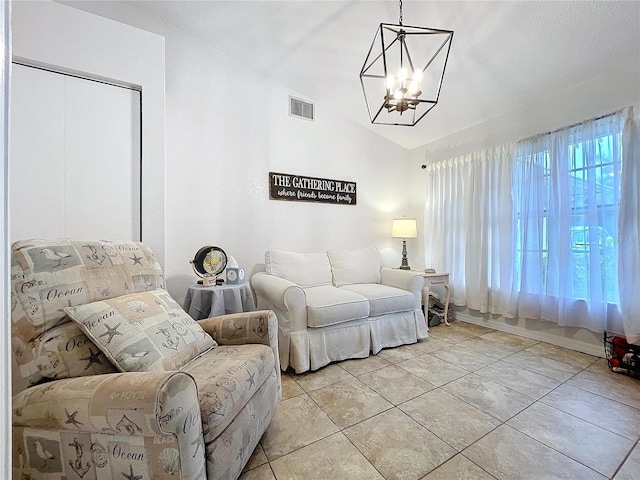 living room featuring a chandelier, lofted ceiling, visible vents, and light tile patterned floors