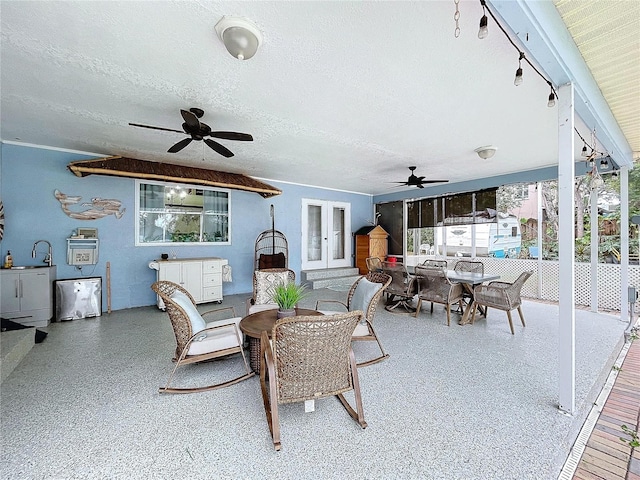 view of patio / terrace featuring ceiling fan, french doors, and outdoor dining space