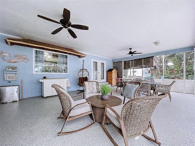 interior space with a textured ceiling, ceiling fan, and plenty of natural light