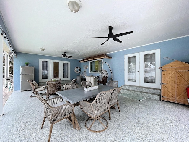 view of patio / terrace with ceiling fan, french doors, and outdoor dining space