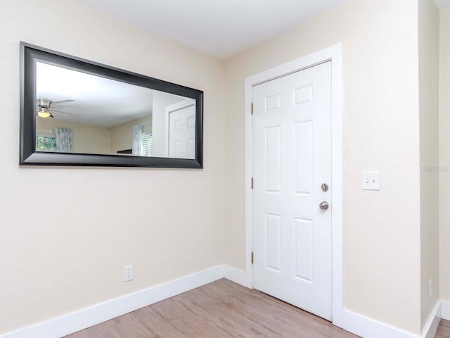 entryway with baseboards and wood finished floors