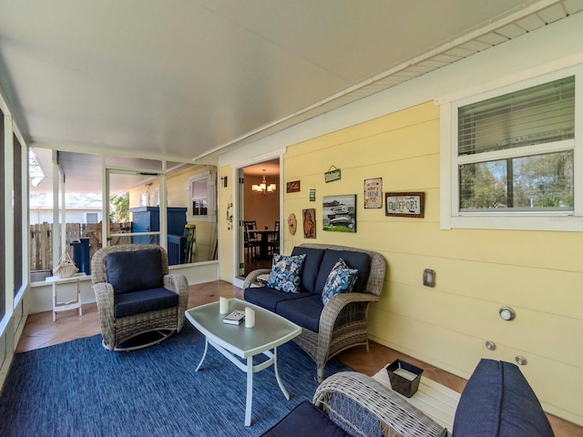 sunroom featuring an inviting chandelier