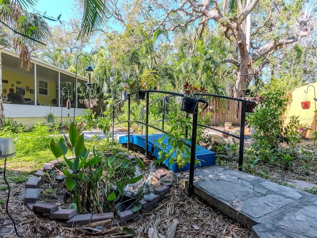 view of yard with a fenced backyard and a sunroom