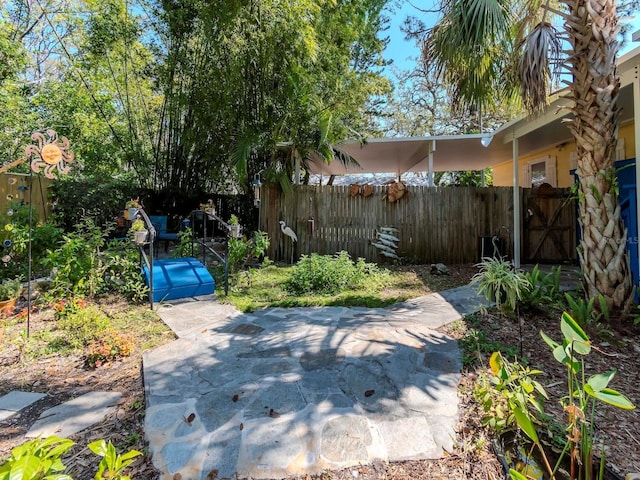 view of yard with a patio area, a gate, and fence