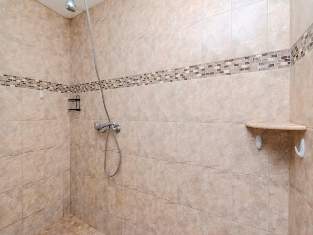 bathroom with tiled shower