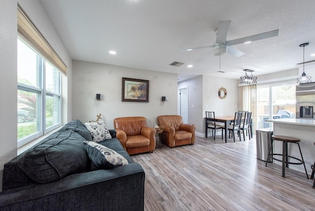 living room featuring recessed lighting, visible vents, baseboards, a ceiling fan, and light wood finished floors