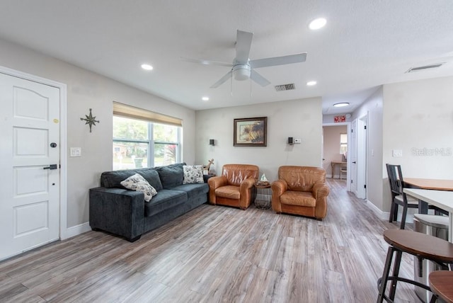 living area featuring baseboards, recessed lighting, visible vents, and light wood-style floors