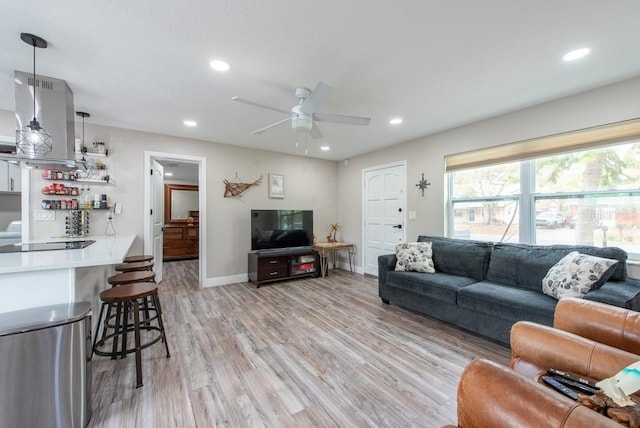 living area with light wood finished floors, baseboards, a ceiling fan, and recessed lighting