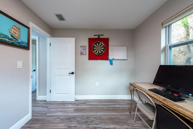 office featuring wood finished floors, visible vents, and baseboards