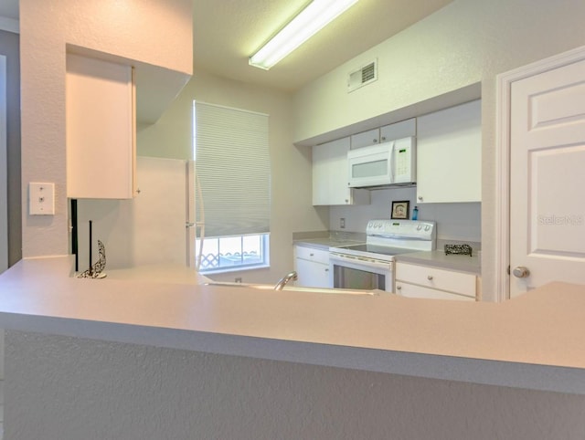 kitchen featuring a peninsula, white appliances, visible vents, white cabinets, and light countertops