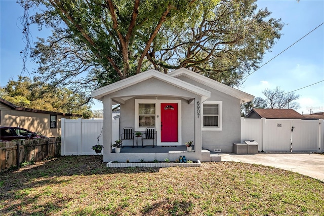 bungalow-style house featuring crawl space, covered porch, a gate, fence, and stucco siding