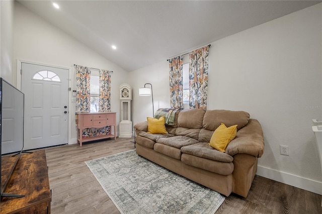 living room featuring high vaulted ceiling, recessed lighting, baseboards, and wood finished floors