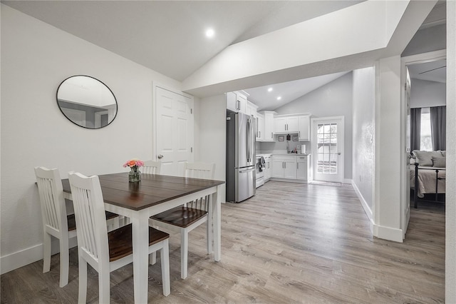 dining area with recessed lighting, baseboards, vaulted ceiling, and light wood finished floors