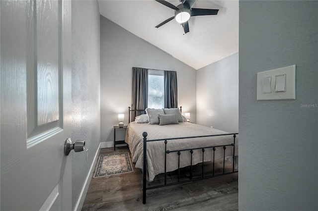 bedroom with lofted ceiling, a textured wall, ceiling fan, wood finished floors, and baseboards