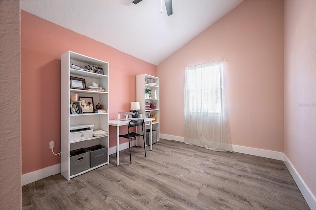 office space featuring lofted ceiling, ceiling fan, baseboards, and wood finished floors