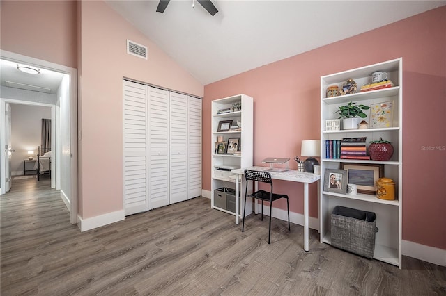 office area with visible vents, ceiling fan, vaulted ceiling, wood finished floors, and baseboards