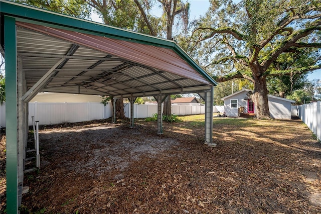 view of parking / parking lot featuring a carport and fence