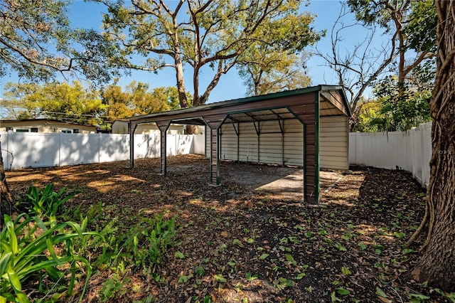 view of yard with a fenced backyard and a detached carport