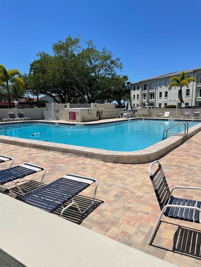 pool featuring a patio area and fence