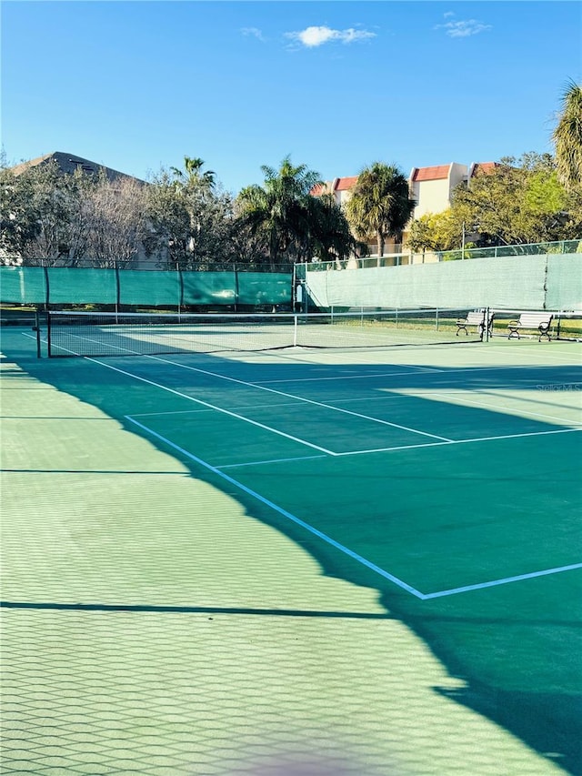 view of tennis court with fence