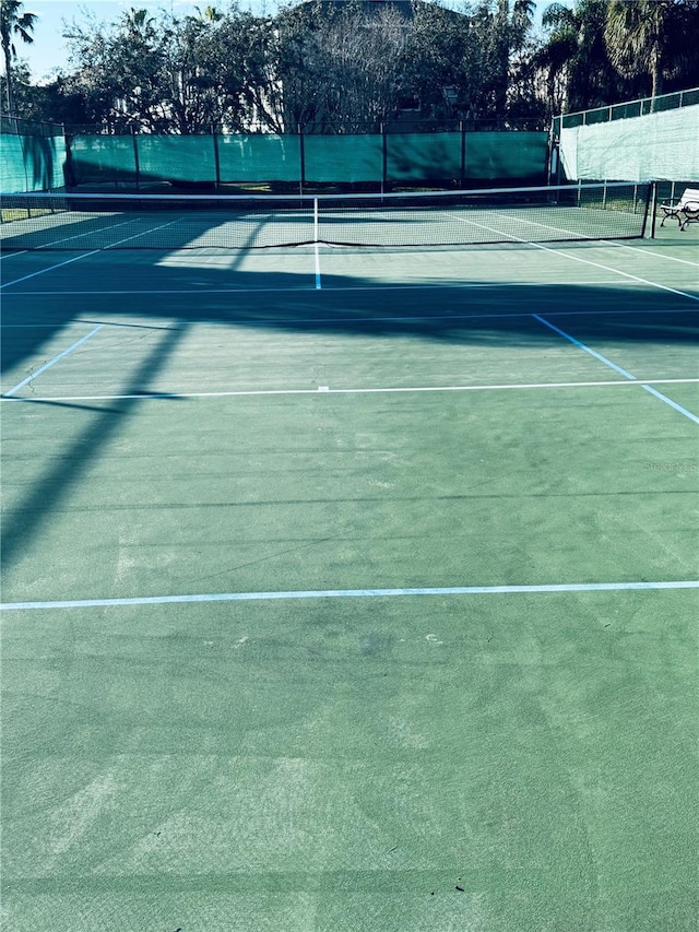 view of sport court featuring fence