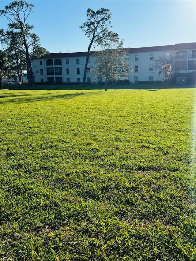 view of property's community with a lawn