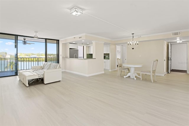 living area featuring ornamental molding, light wood-type flooring, visible vents, and baseboards