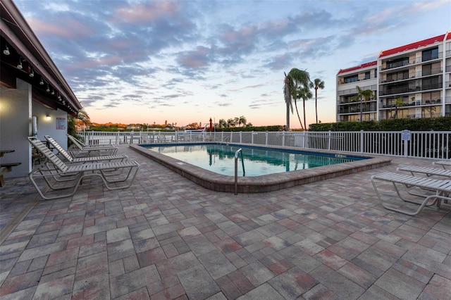 pool with fence and a patio