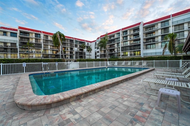 pool featuring a patio area and fence