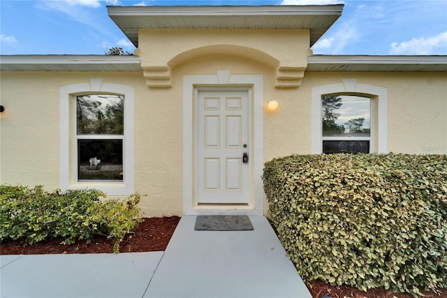 view of exterior entry with stucco siding