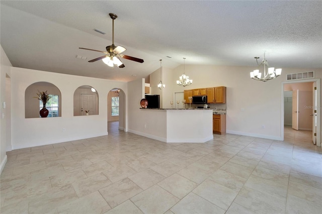 unfurnished living room featuring lofted ceiling, visible vents, a textured ceiling, and ceiling fan with notable chandelier