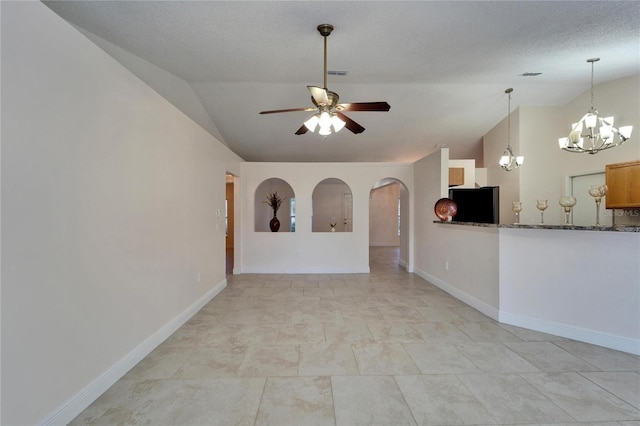 unfurnished room with vaulted ceiling, baseboards, and ceiling fan