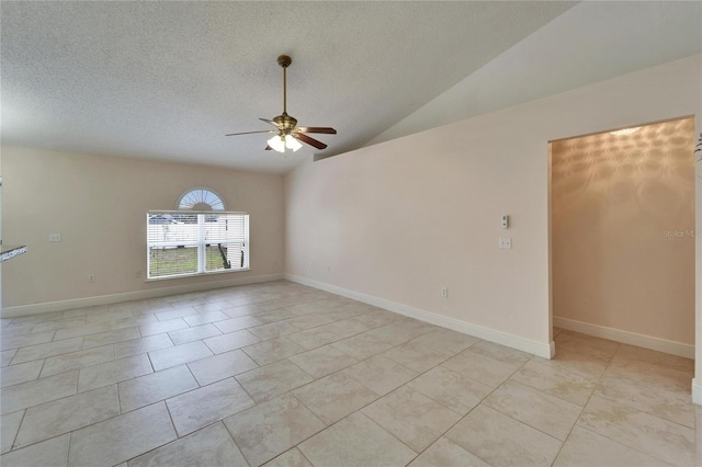 empty room featuring lofted ceiling, ceiling fan, a textured ceiling, light tile patterned flooring, and baseboards