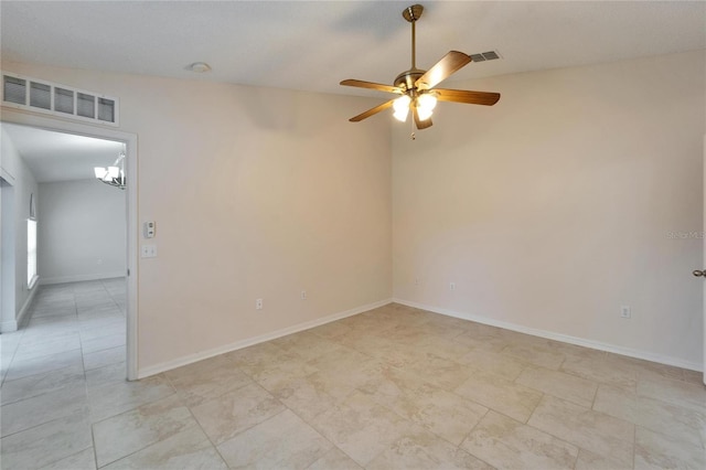 unfurnished room featuring baseboards, visible vents, and a ceiling fan