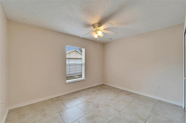 unfurnished room featuring ceiling fan, a textured ceiling, and baseboards