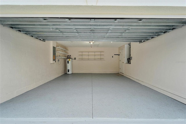 garage featuring water heater, electric panel, and concrete block wall