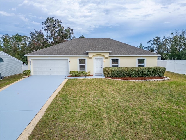 ranch-style house featuring a garage, fence, concrete driveway, stucco siding, and a front lawn