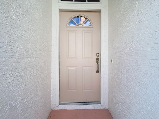 property entrance featuring stucco siding