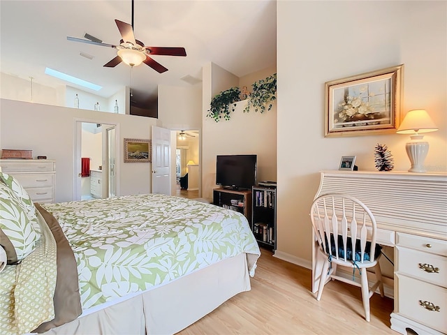 bedroom featuring light wood-style flooring, a skylight, visible vents, and high vaulted ceiling