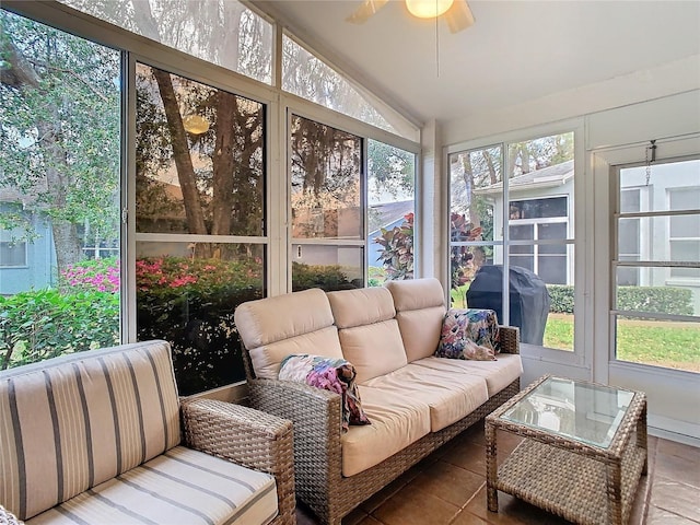 sunroom / solarium with lofted ceiling, a wealth of natural light, and ceiling fan