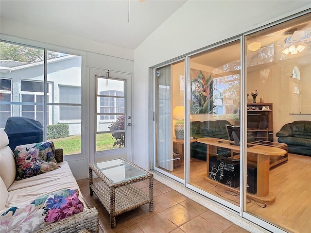 sunroom featuring vaulted ceiling