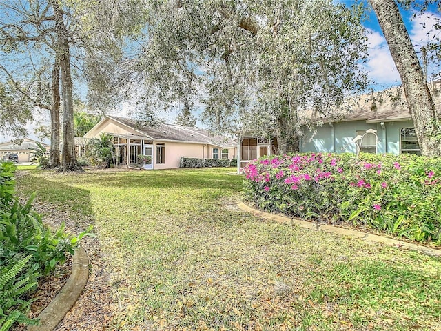 view of yard with a sunroom