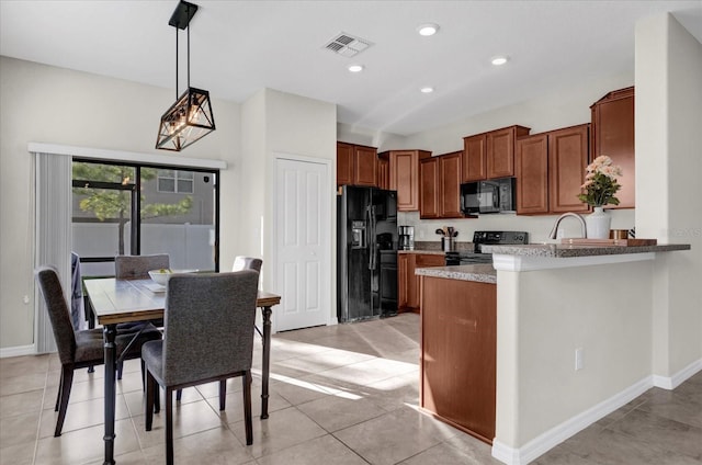 kitchen with visible vents, black appliances, a peninsula, brown cabinetry, and hanging light fixtures